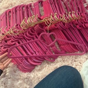Juicy Couture Pink Heart-Shaped and crown-shaped plastic hangers.